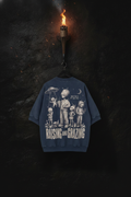 Abducted — navy acid-wash tee on a forged-iron torch in the cavern